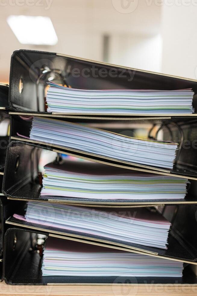 Files stacked on filing cabinet. Overflowing with documentation photo