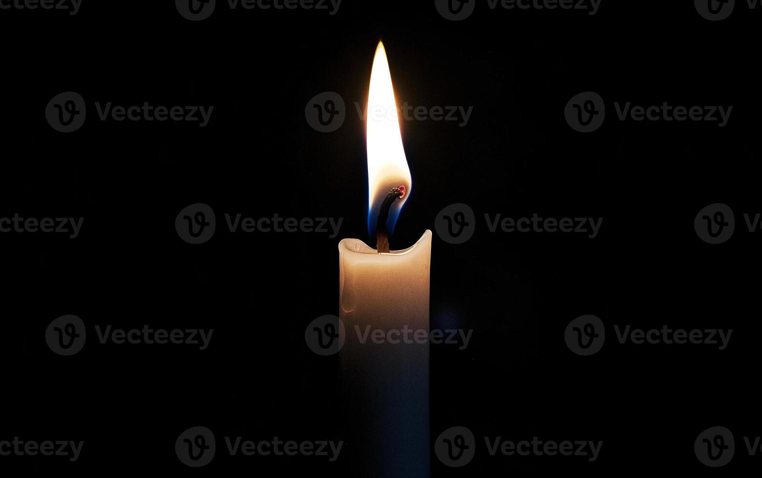 Burning white candle on black background. Close-up photo. With copy space. Image for memory of events and people photo