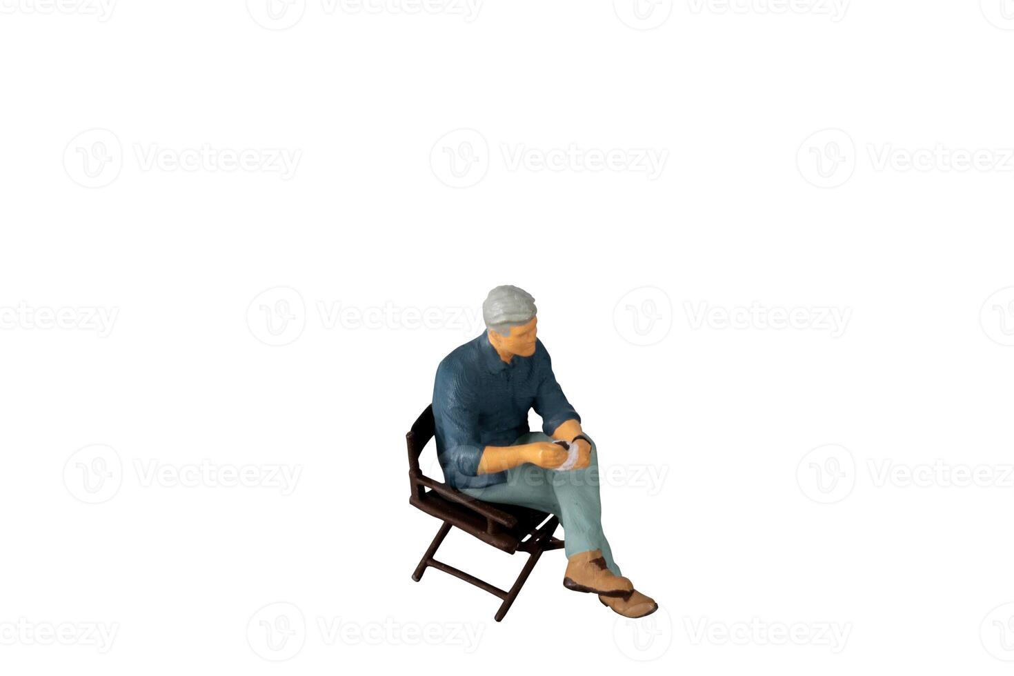 A businessman seated on a chair and sipping hot coffee isolated on white background with clipping path photo