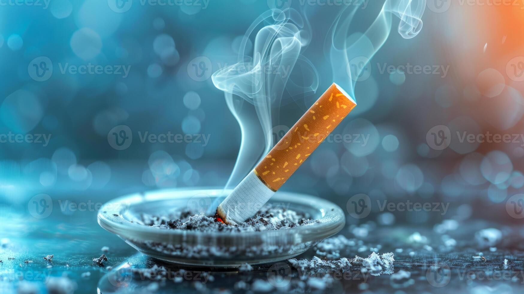 Smoldering cigarette on ashtray amidst soft blue hazy backdrop. photo