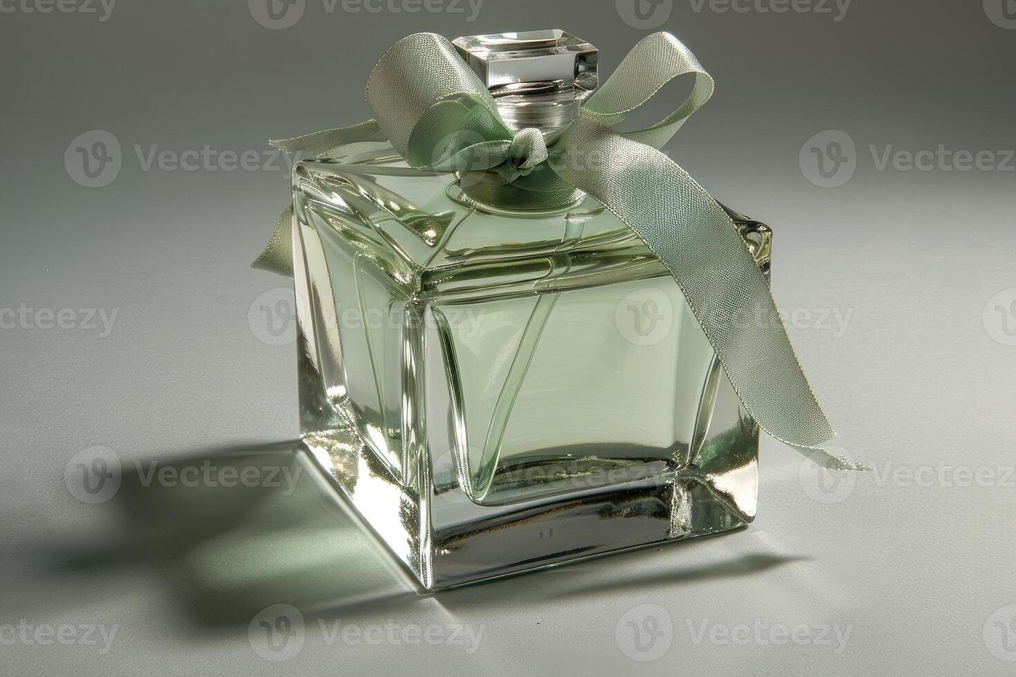 Bottle of woman's perfume. A light green ribbon label is on the bottle. photo