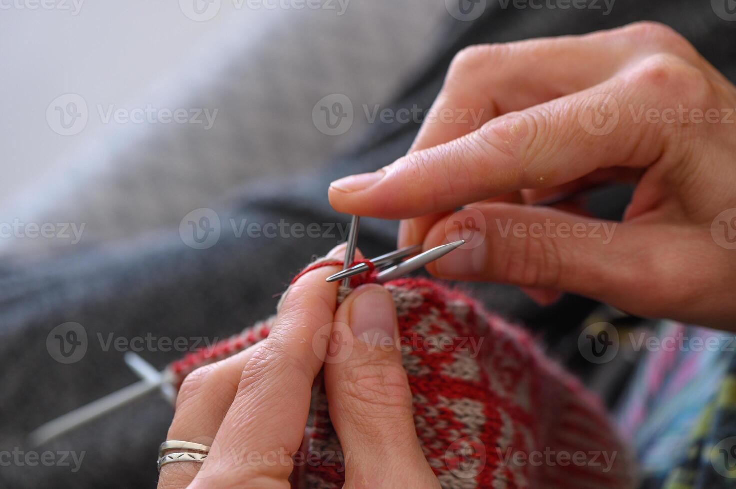 Close up of the hands of an woman knitting sock photo