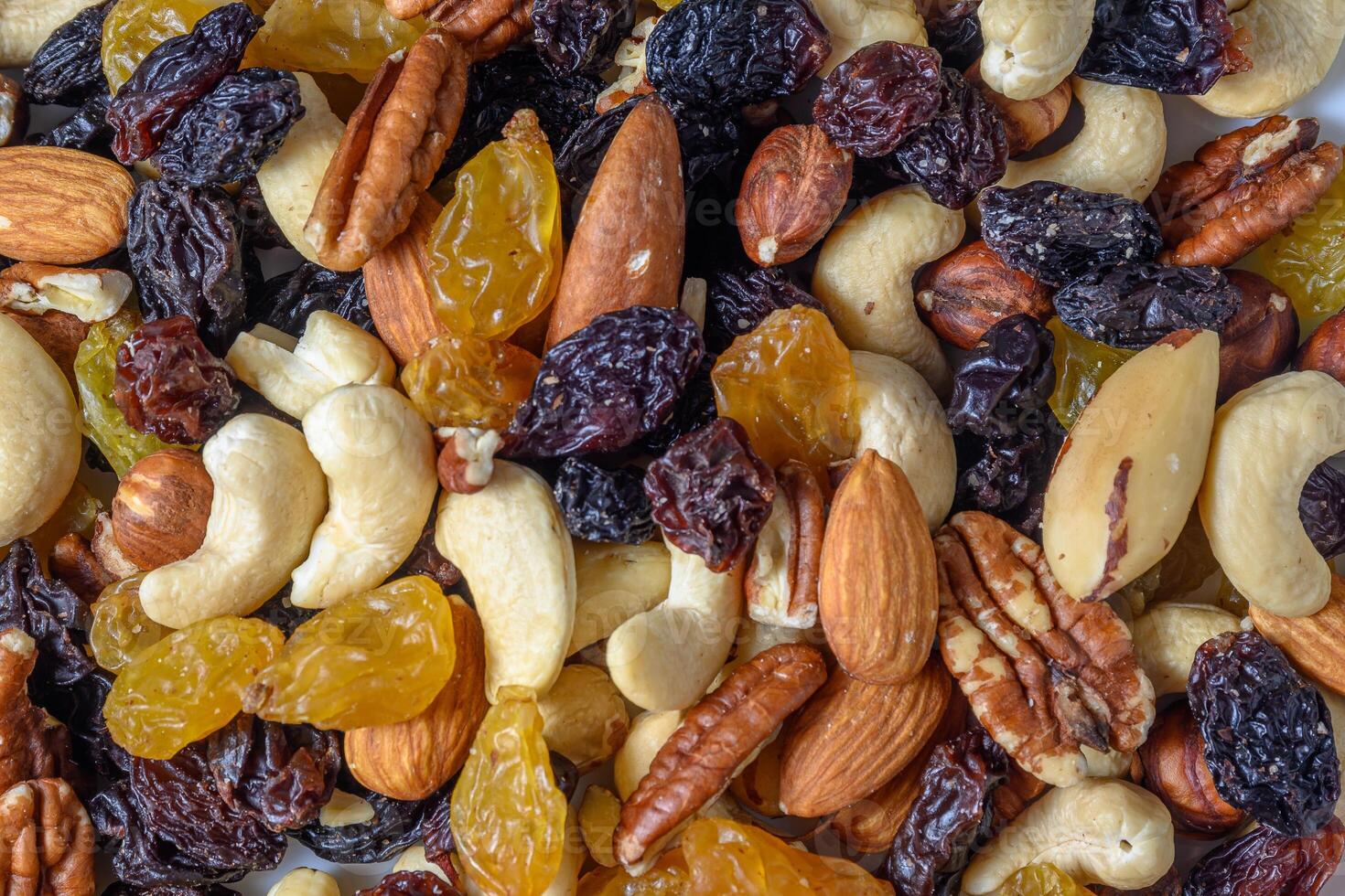 background with a cashew, hazelnuts, raisins and peanuts. Mixed nuts and raisins texture.13 photo