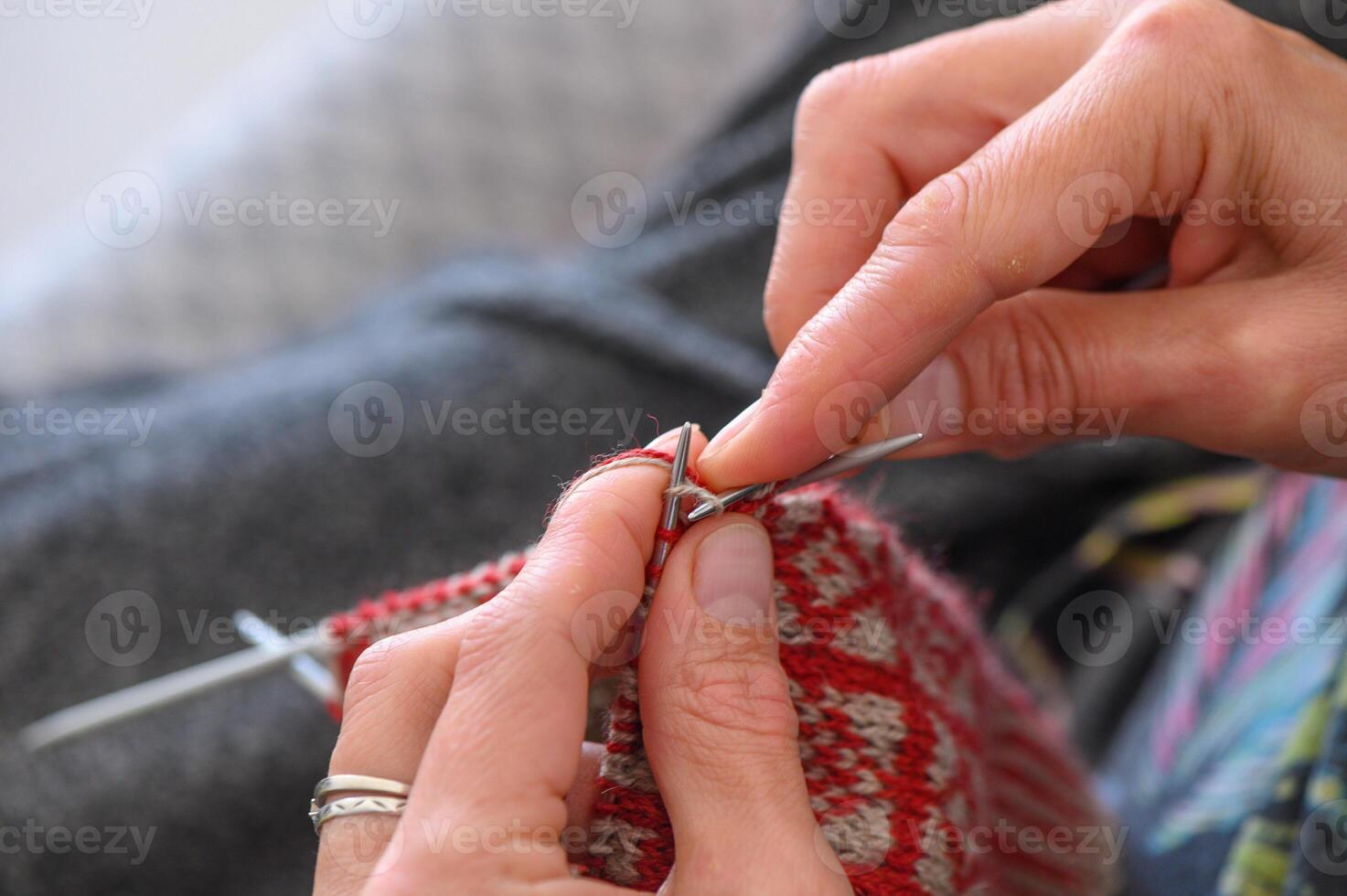 Women's hands knit socks from yarn. Knitting socks is a great activity for women.1 photo