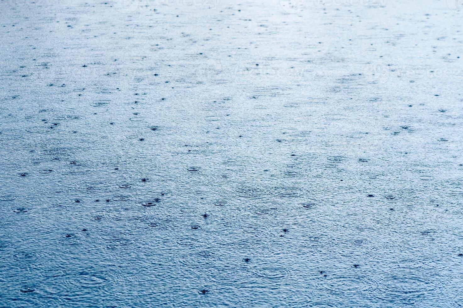 River in the rain. Water surface during a downpour photo