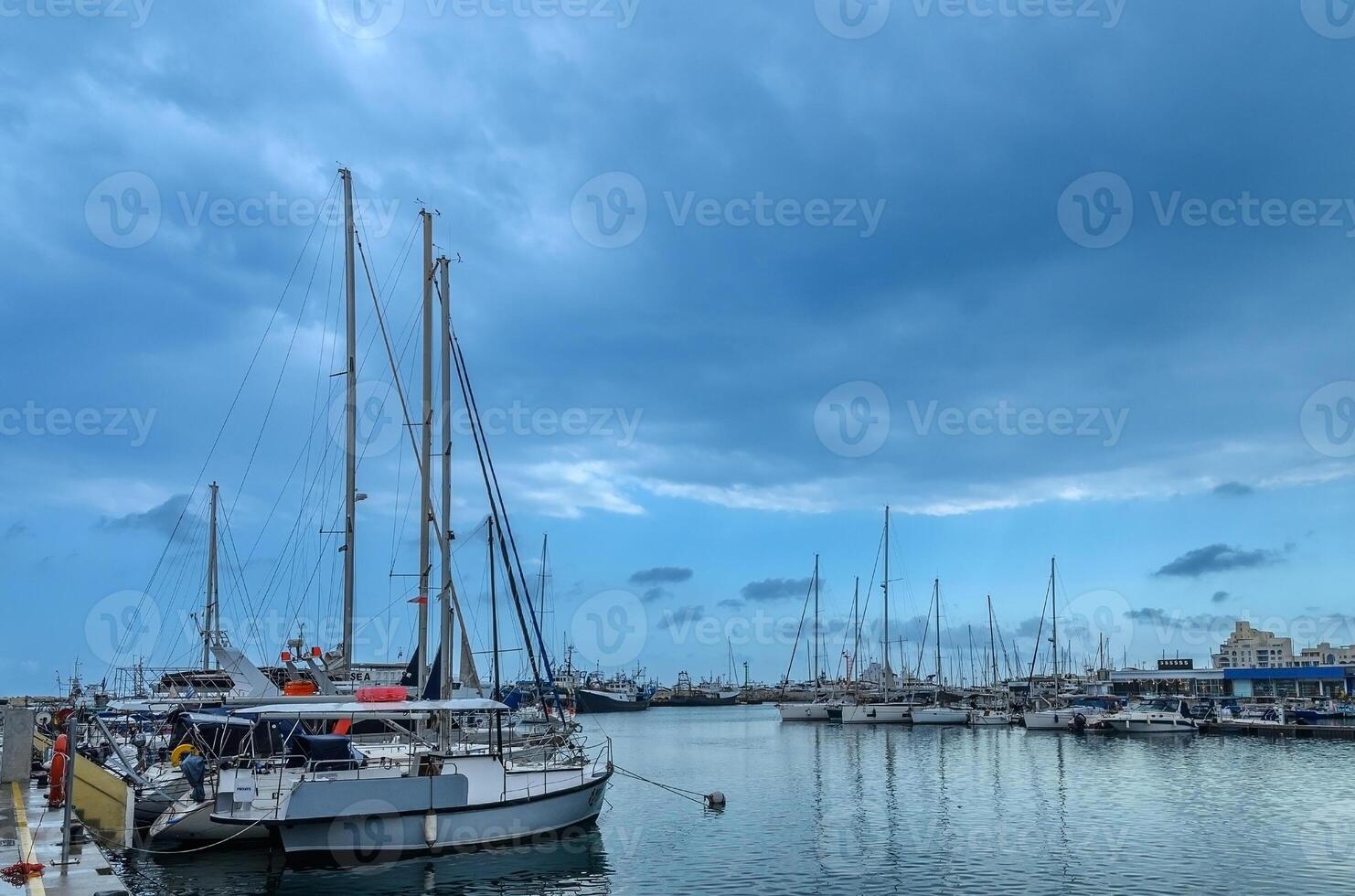 yachts and ships in the port in Limassol Cyprus in spring cloudy photo