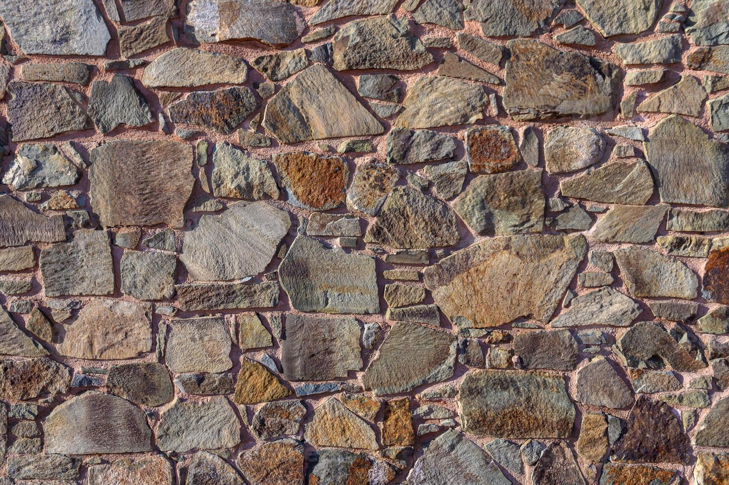 Stone cladding wall made of striped stacked slabs of natural brown rocks. Panels for exterior . photo