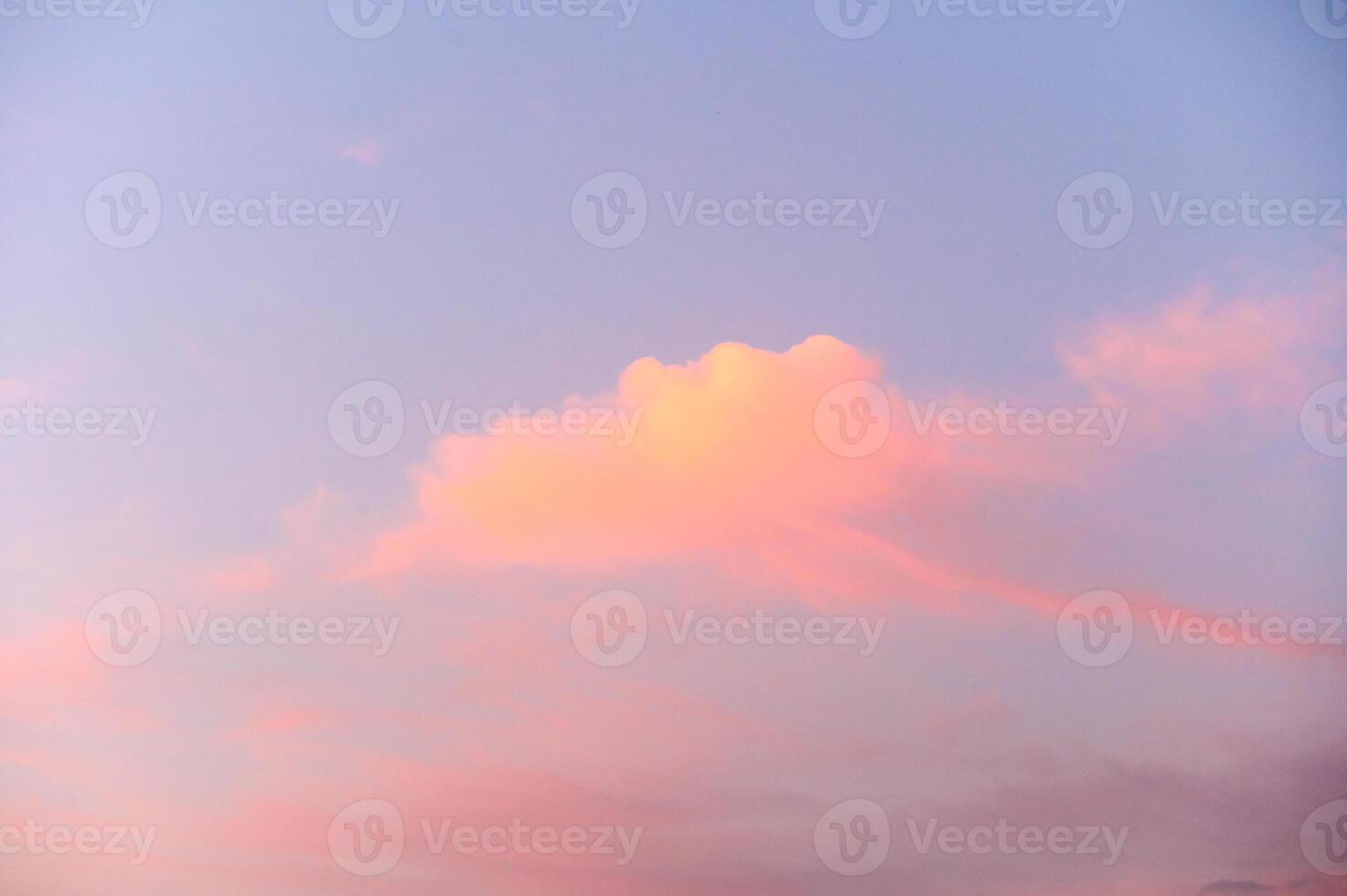 Light pink clouds in sunset blue sky. photo