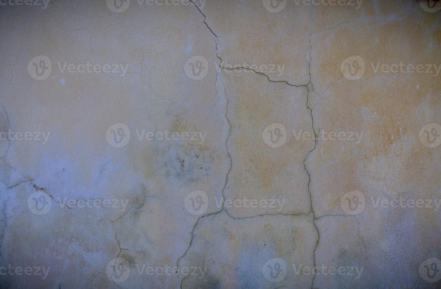 cracked concrete wall covered with gray cement surface as background photo