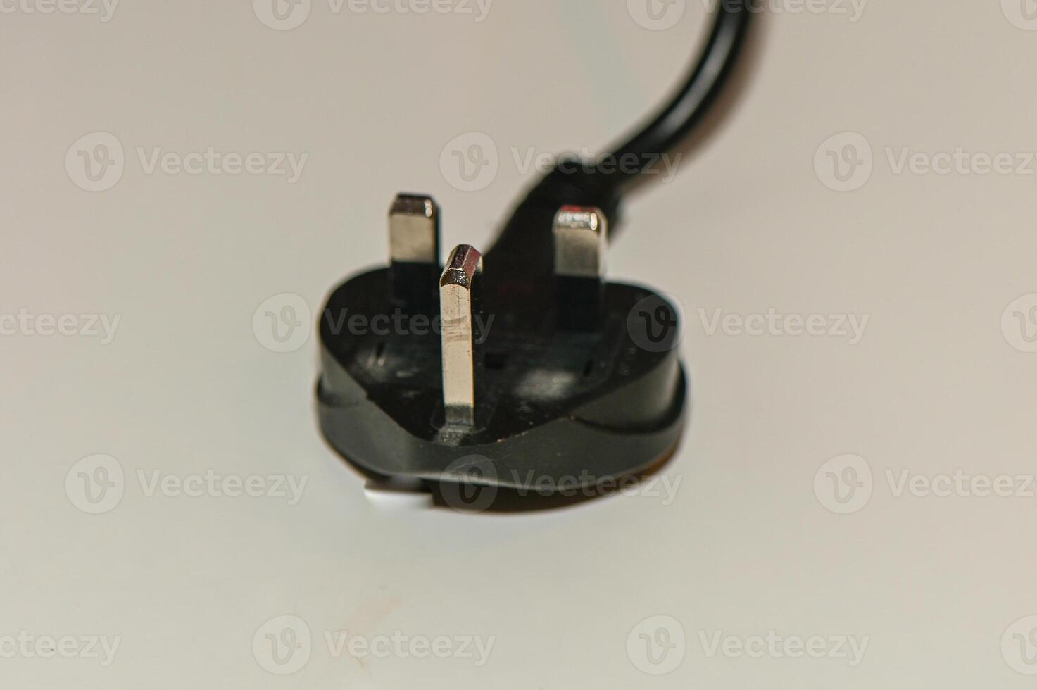 black plug from English standard socket on the table 1 photo
