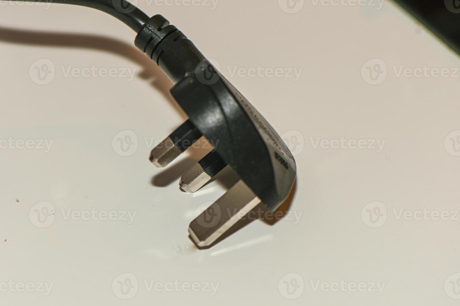 black plug from English standard socket on the table 3 photo