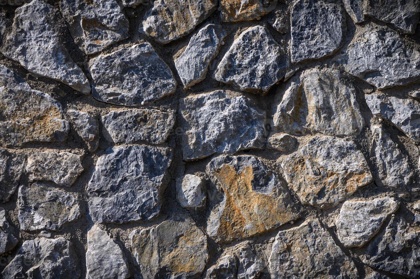 grey stone dark wall of medieval horizontal stones facade background 4 photo