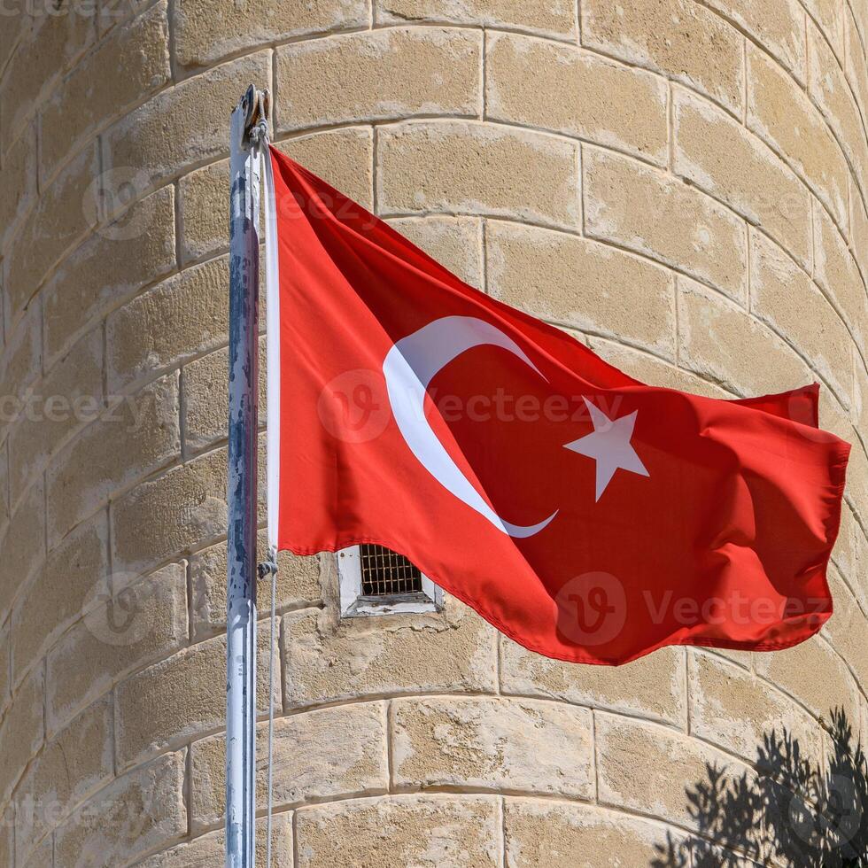 Turkish flag on the background of a brick wall of the mosque 2 photo
