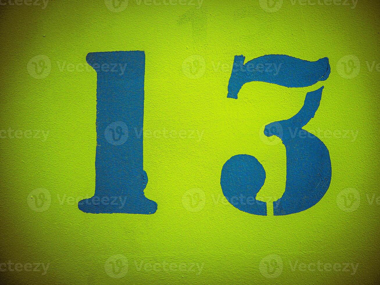 number thirteen painted on yellow wall with vignette photo