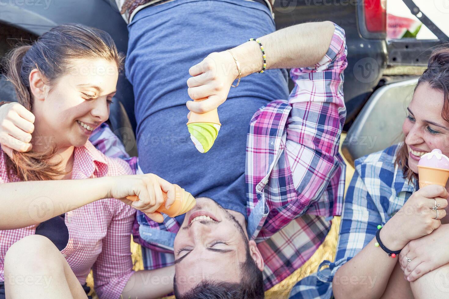 group of young adults make crazy and eat the ice cream photo