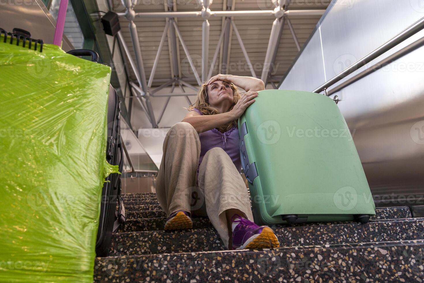 tired tourist traveler waiting sitting on the stairs photo