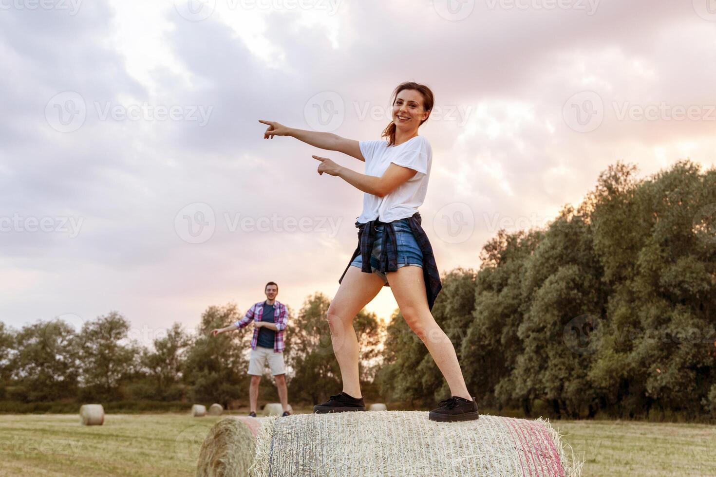 young millennial couple are doing synchronized gymnastics on the sheaves photo