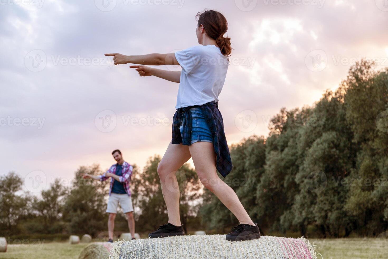 young millennial couple are doing synchronized gymnastics on the sheaves photo