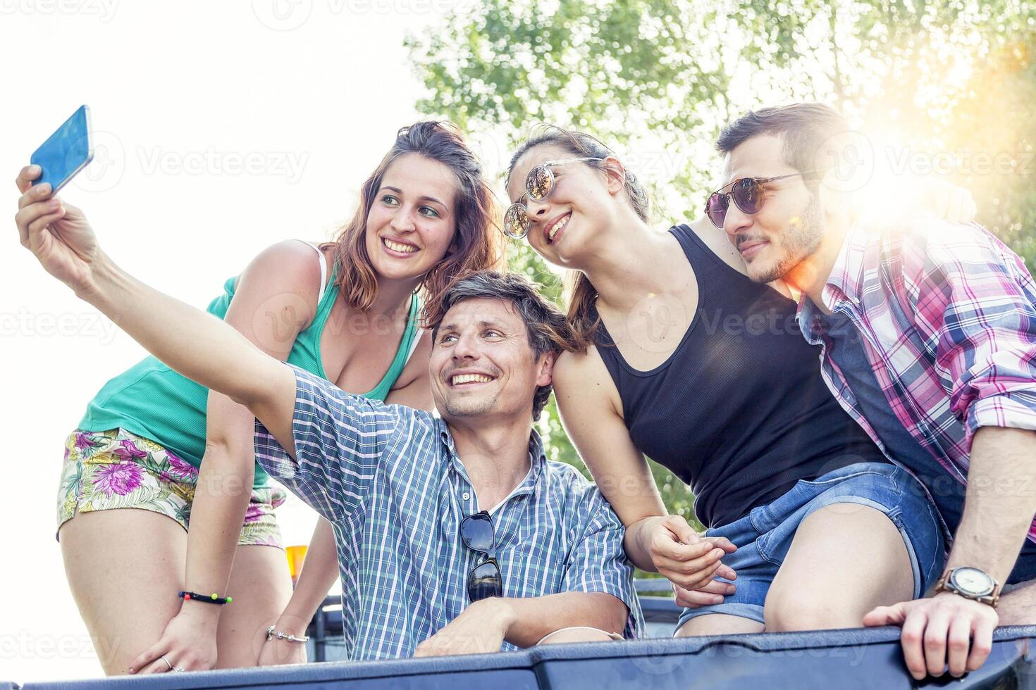 Happy group of young people takes a selfie photo