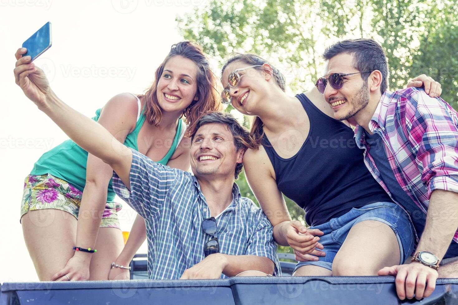 Happy group of young people takes a selfie photo