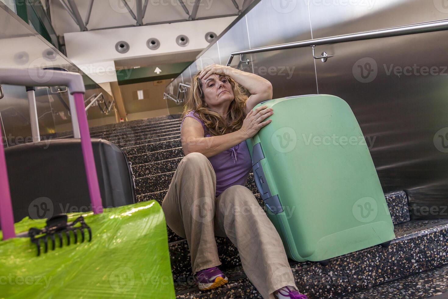 tired tourist traveler waiting sitting on the stairs photo