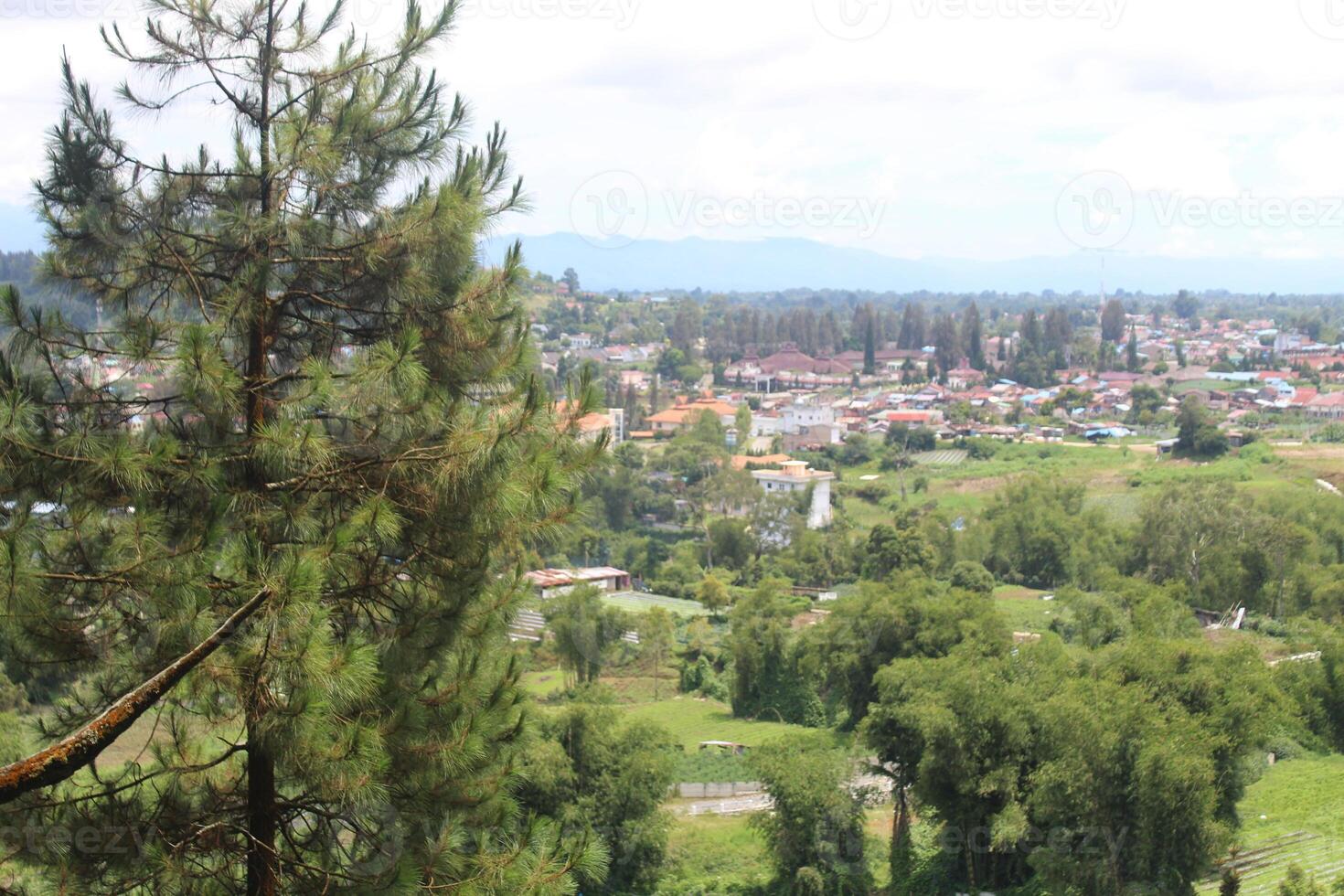 a city with mountains in the background and the city in the background. photo