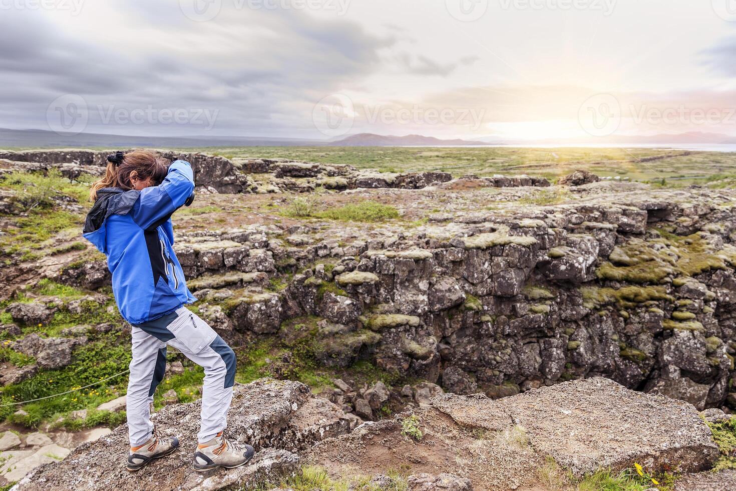 female nature photographer in action photo