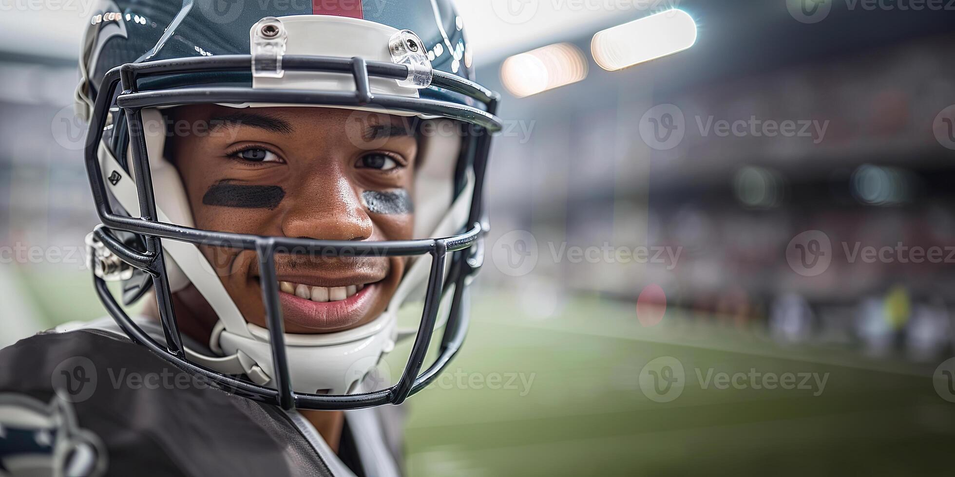 American football players in a black helmet and uniform smiling against the background of the stands and the football field. Copy space photo