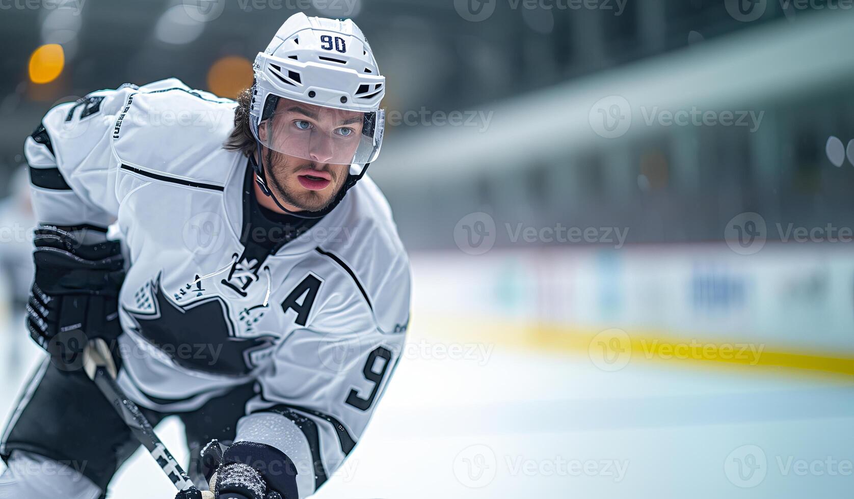 A hockey player in a black and white uniform at the hockey arena during a match on the left side of the frame. Copy space photo