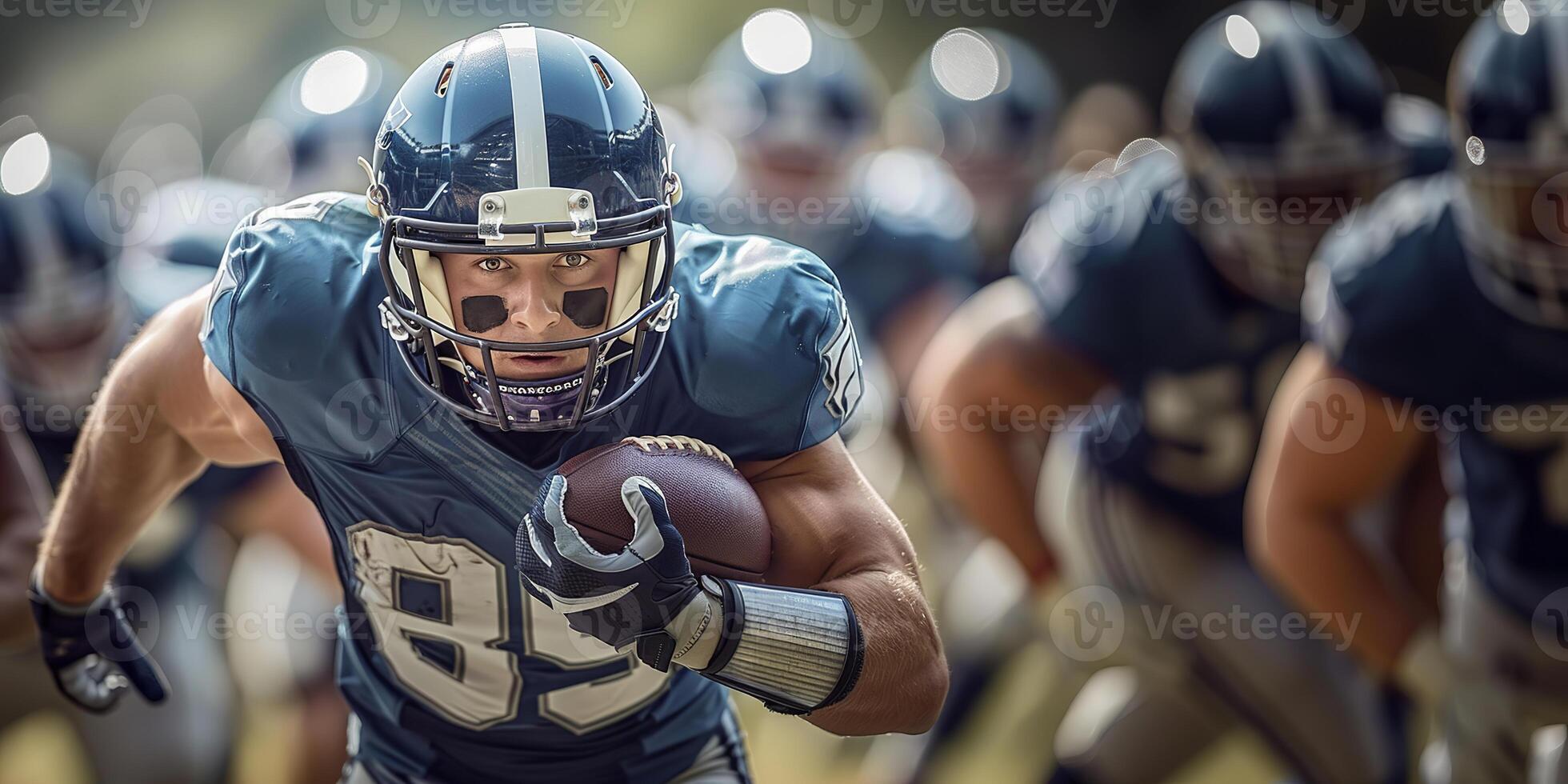 American football player runs with the ball in his left hand during a match. In the background, the players of their team are running behind their backs. Copy space photo