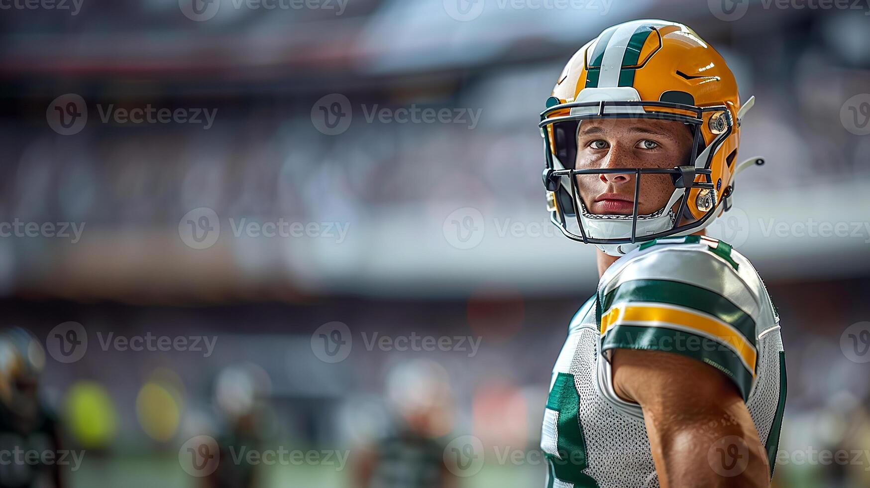 American football player in a yellow helmet and white uniform stands with his left side against the background of the stands. Copy space photo