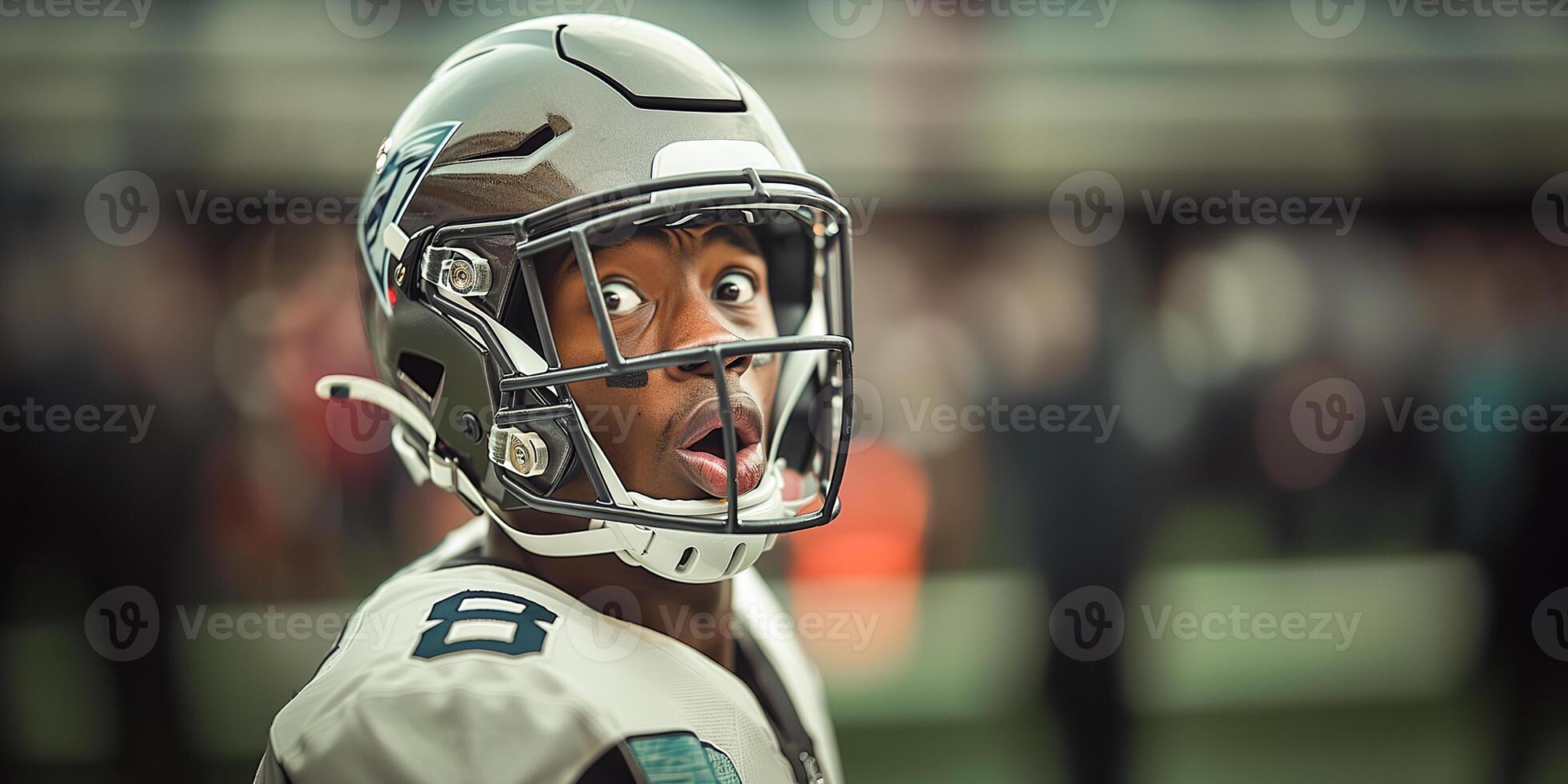 An American football player in a black helmet and white uniform made a very surprised face. Copy space photo