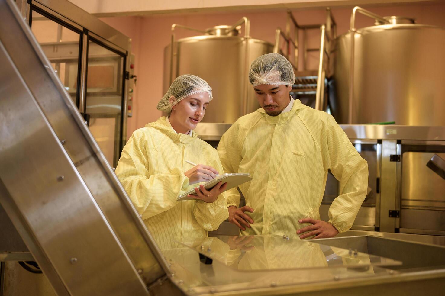 Professional winemaker controlling wine making process and quality at winery factory photo
