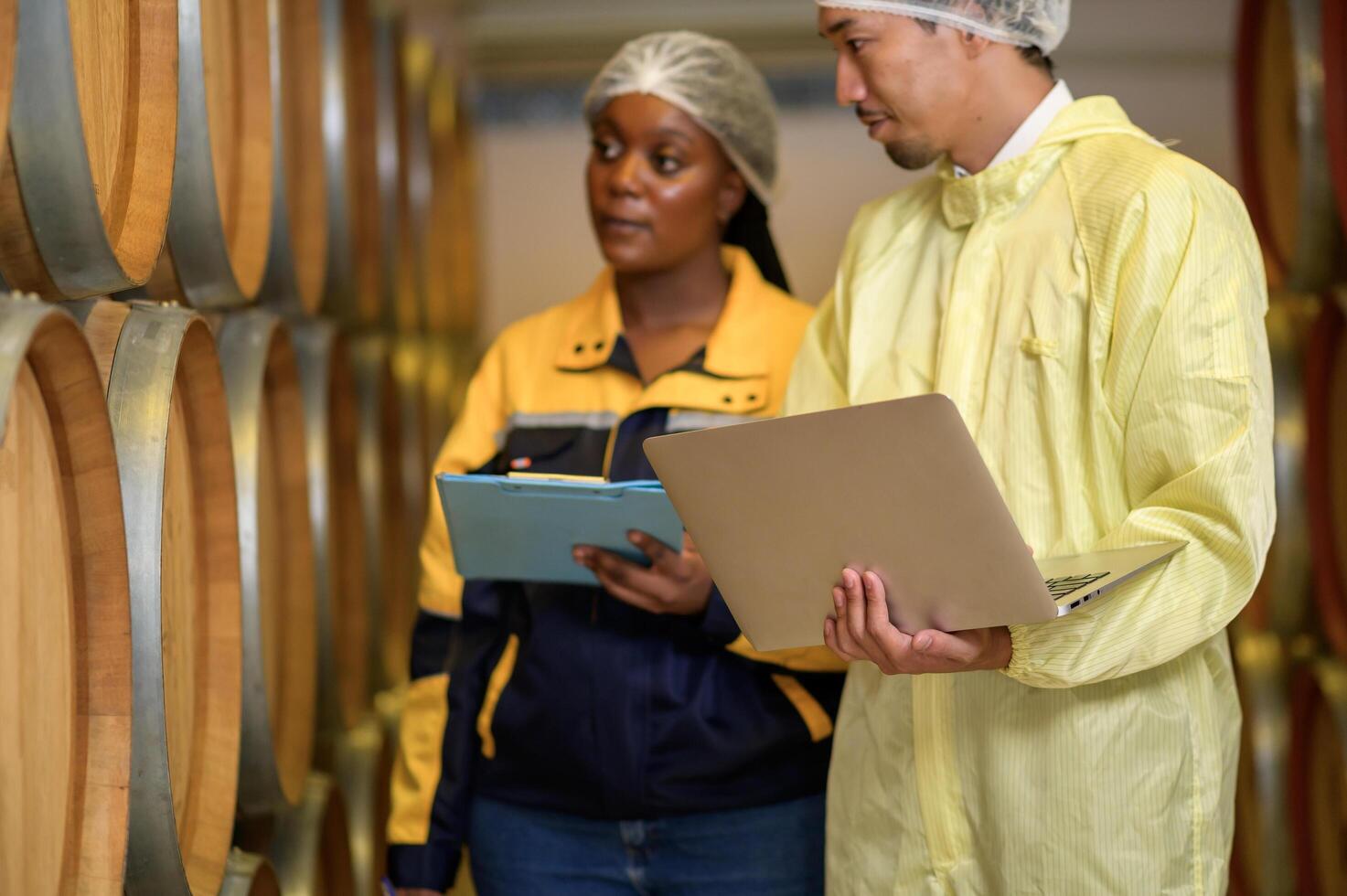 Professional winemaker controlling wine making process and quality at winery factory photo