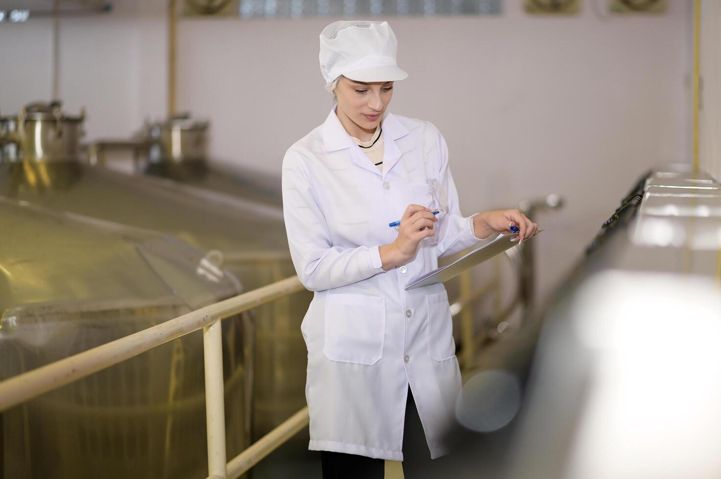 Professional winemaker controlling wine making process and quality at winery factory photo