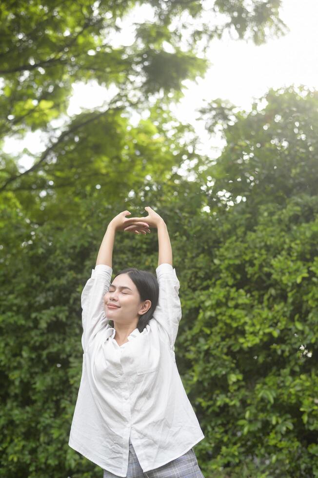 A young healthy woman smiling , refreshing in nature background photo