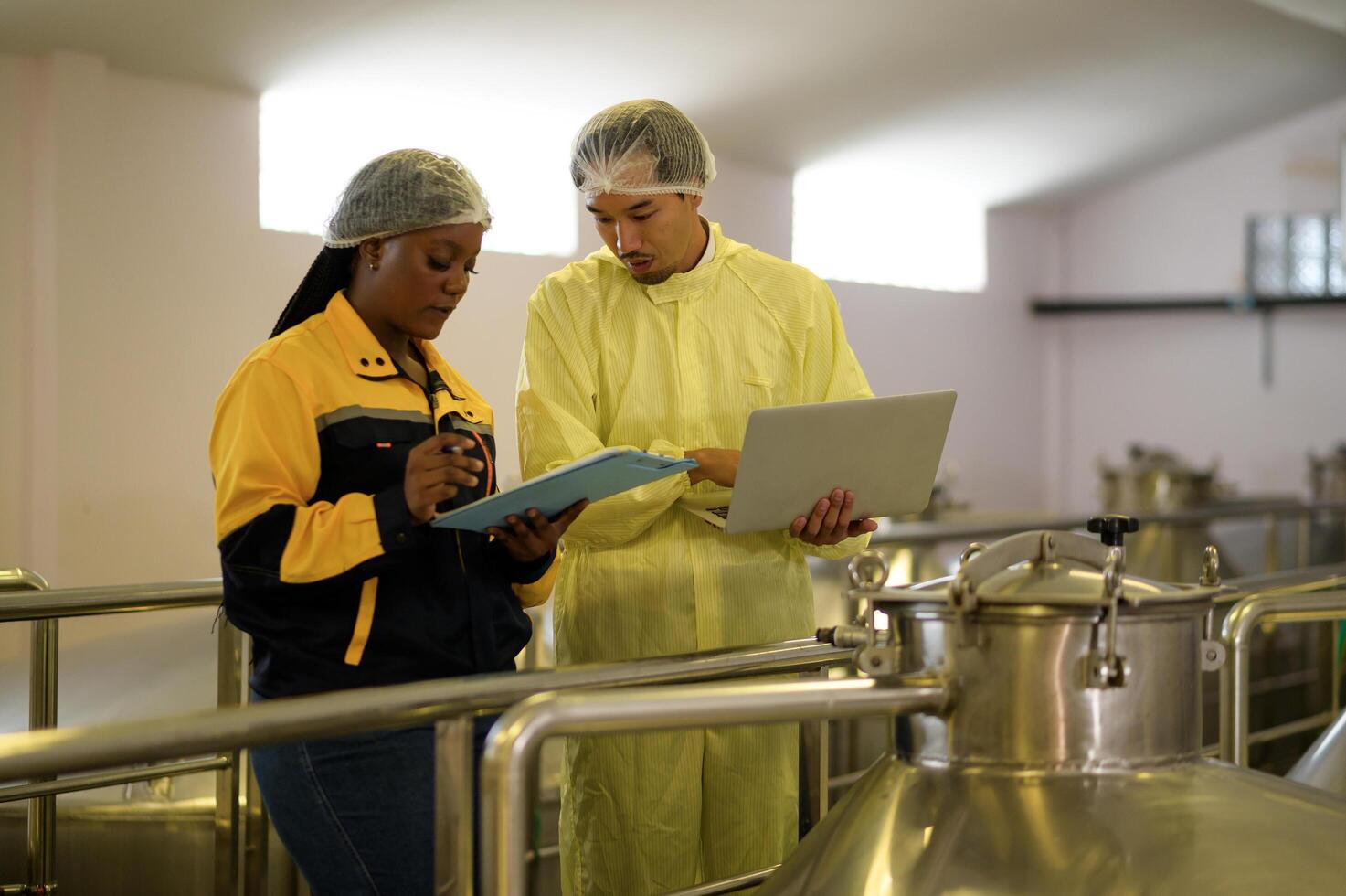 Professional winemaker controlling wine making process and quality at winery factory photo