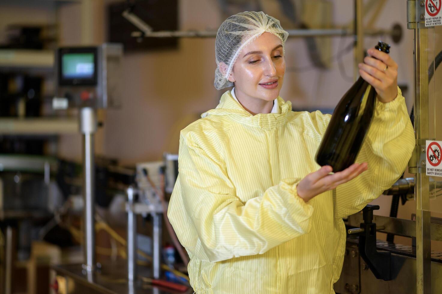 Professional winemaker controlling wine making process and quality at winery factory photo