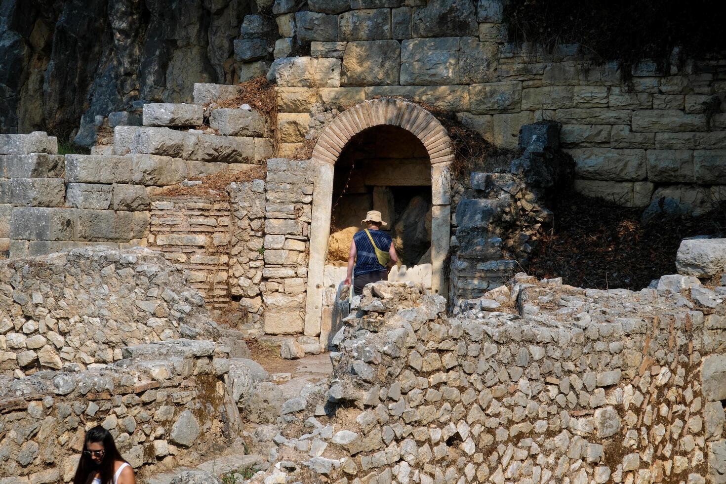 Albania 09.09.2023 Ruins of Great Basilica in Butrint National Park, Buthrotum, Albania. Triconch Palace at Butrint Life and death of ancient Roman house Historical medieval Venetian Tower surrounded photo
