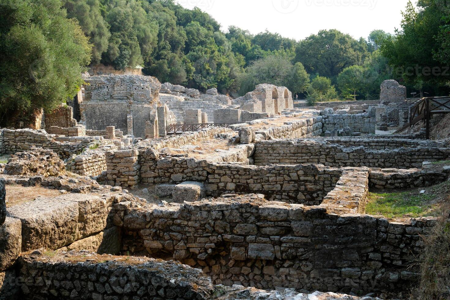 Ruins of the Great Basilica in Butrint National Park, Buthrotum, Albania. Triconch Palace at Butrint Life and death of an ancient Roman house Historical medieval Venetian Tower surrounded photo