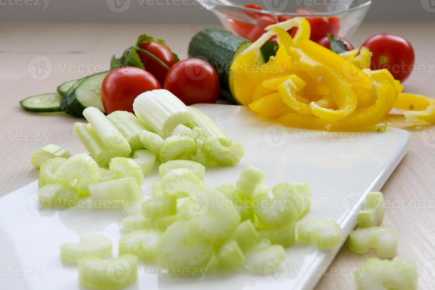 Sliced fresh celery or Celery stalk on cutting wooden board photo