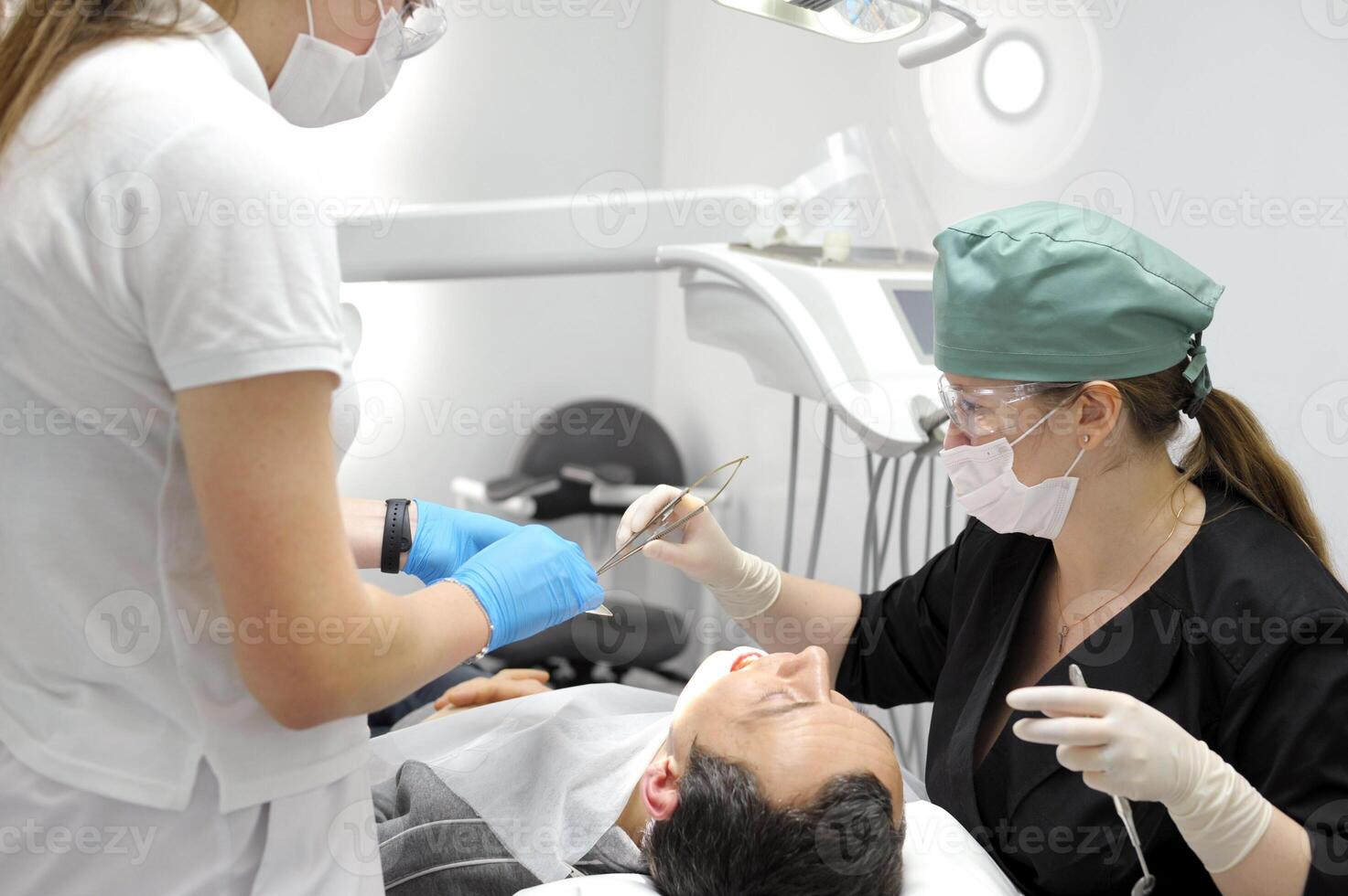 Installation of a dental implant. Restoration of missing teeth with an implant. The doctor stitches up the wound in the oral cavity. A close-up shot. The concept of dental and dental care. veneers photo