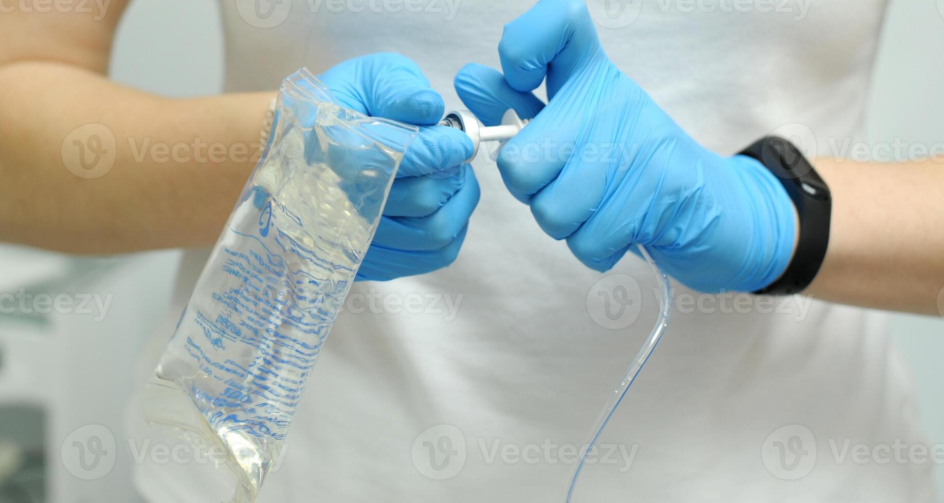 saline gloves dentistry The nurse collects the saline solution of sodium chloride from the bottle into the syringe. Antibiotic breeding, vaccination, prevention and treatment of diseases photo