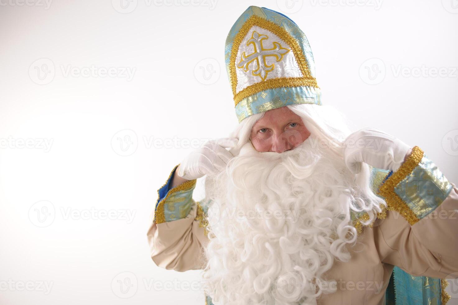 different positive emotions of St. Nicholas the Wonderworker who was founder of Santa Claus St. Nicholas is popularly called he is dressed in turquoise suit with gold with traditional religious cap photo