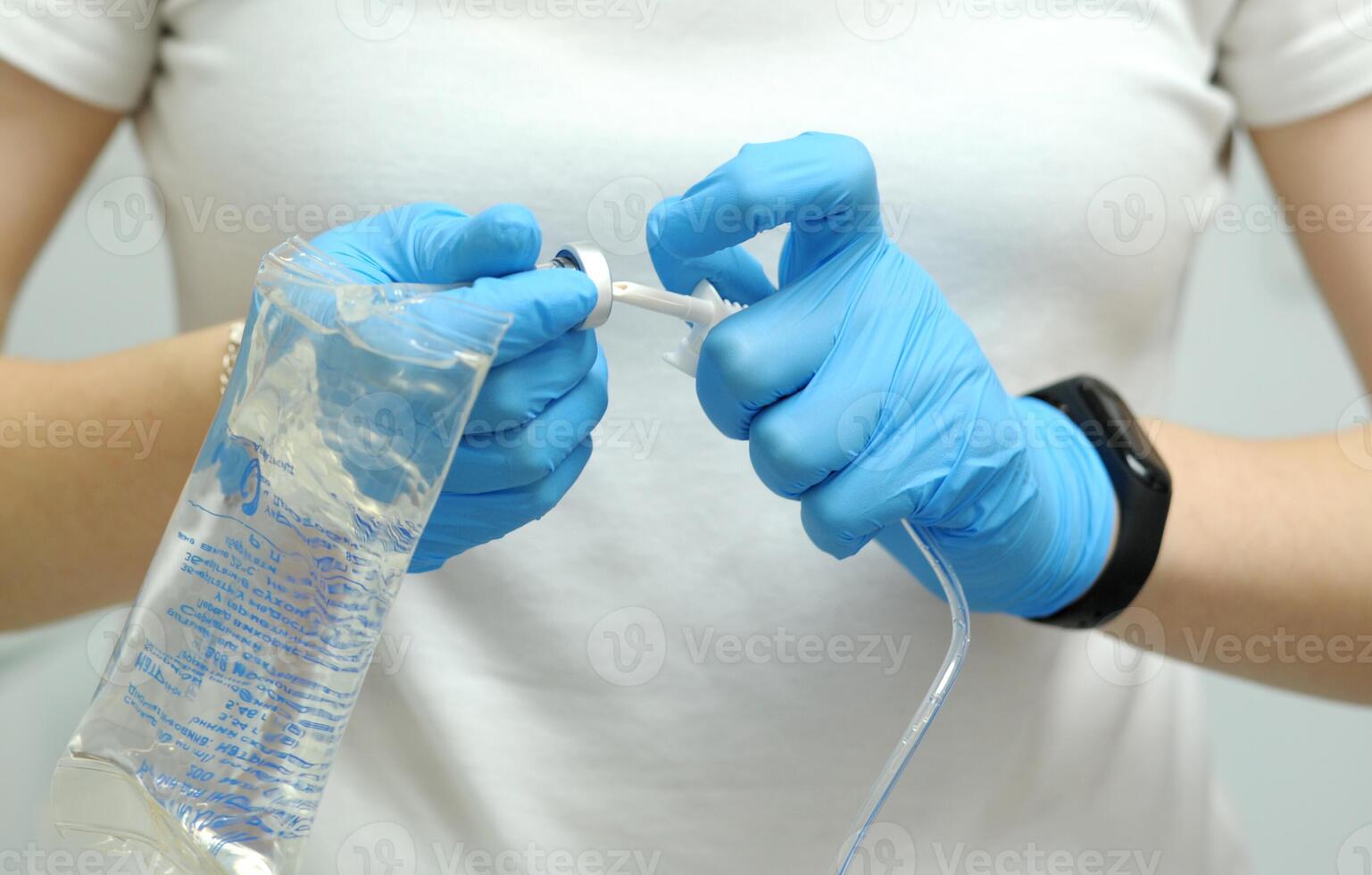 saline gloves dentistry The nurse collects the saline solution of sodium chloride from the bottle into the syringe. Antibiotic breeding, vaccination, prevention and treatment of diseases photo