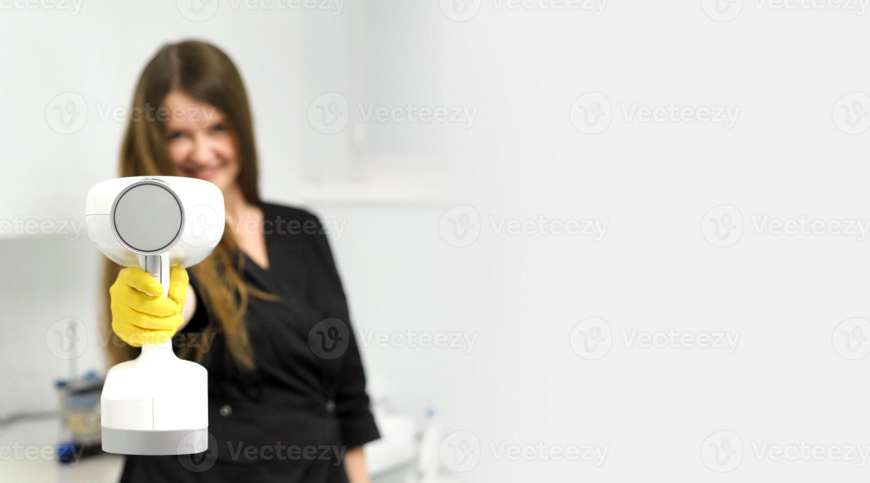 portable x-ray beautiful young female doctor in her hands with a portable x-ray prepared to take a picture for an advertisement banner beautifully interesting bright space for text white background photo