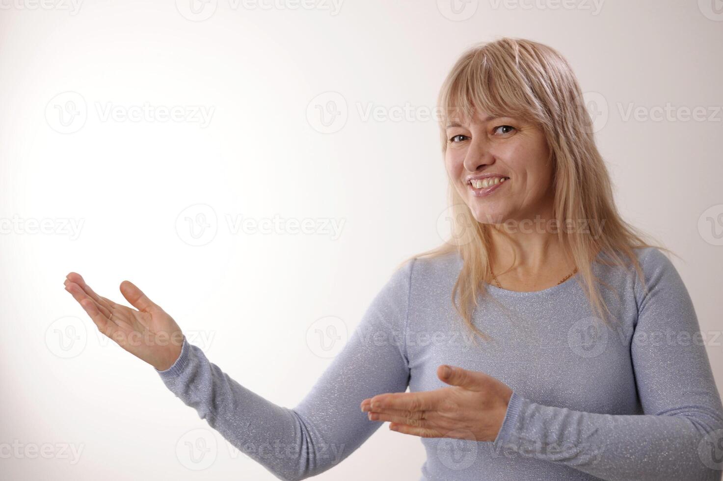 Photo of senior woman happy positvie smile hold hands product promo offer isolated over grey color background