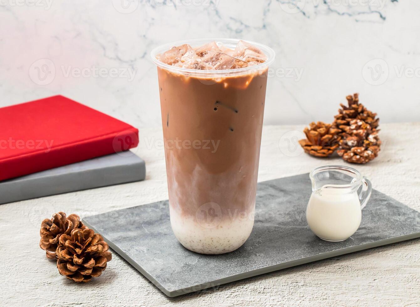 Iced Cocoa Latte served in disposable glass isolated on board side view of taiwanese iced drink photo