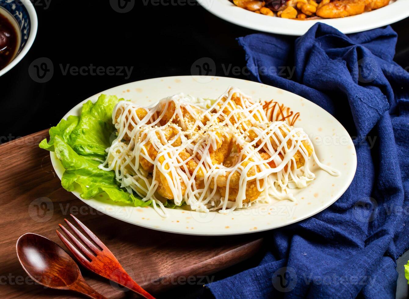 Pineapple Shrimp Balls with white sauce, spoon and fork served in dish isolated on wooden board side view of taiwan food photo