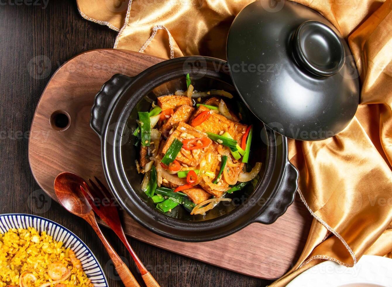 Lao Pi tender tofu with fork and spoon served in dish isolated on wooden board top view of asian food photo